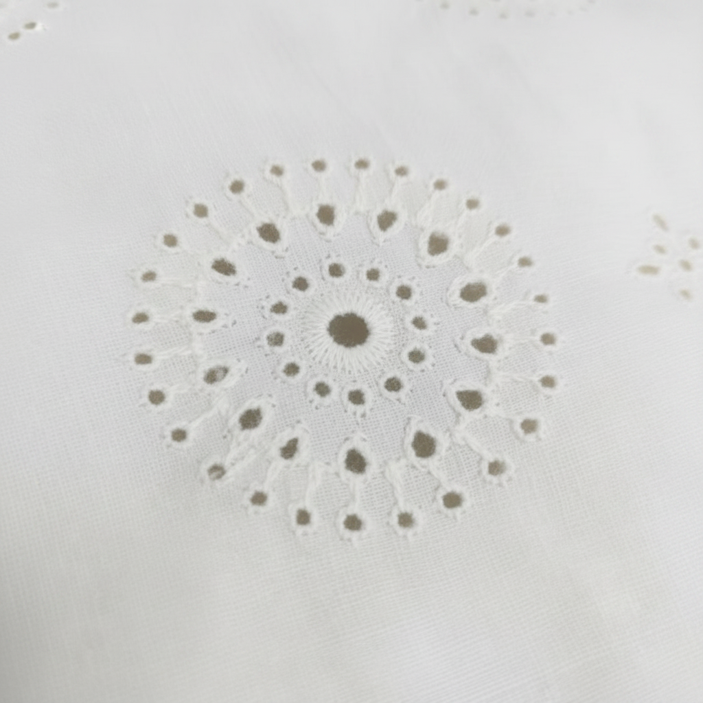 Off-white minimal circular floral medallion Hakoba eyelet embroidery cotton fabric close-up