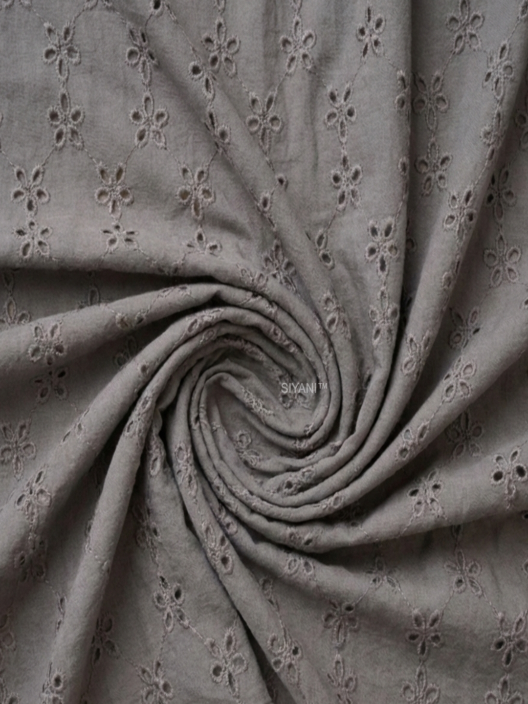 Gray five hole pentagon schiffli fabric