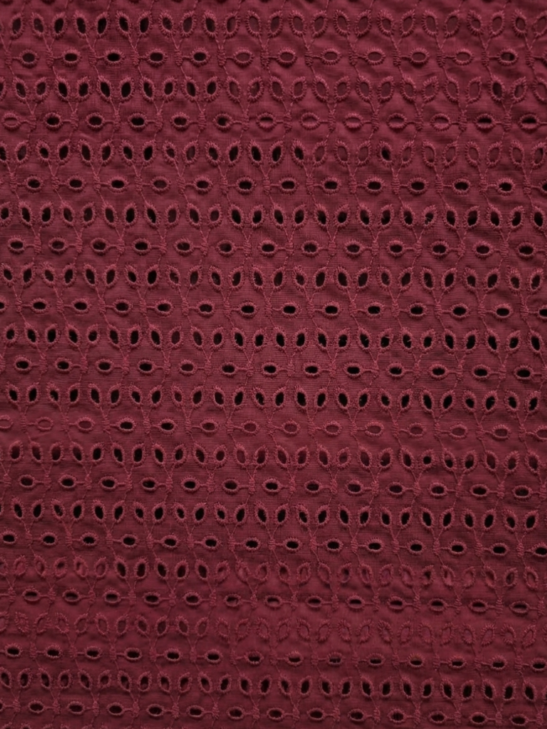 Maroon six hole schiffli embroidered fabric
