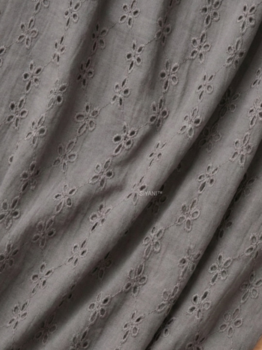 Gray five hole pentagon schiffli fabric