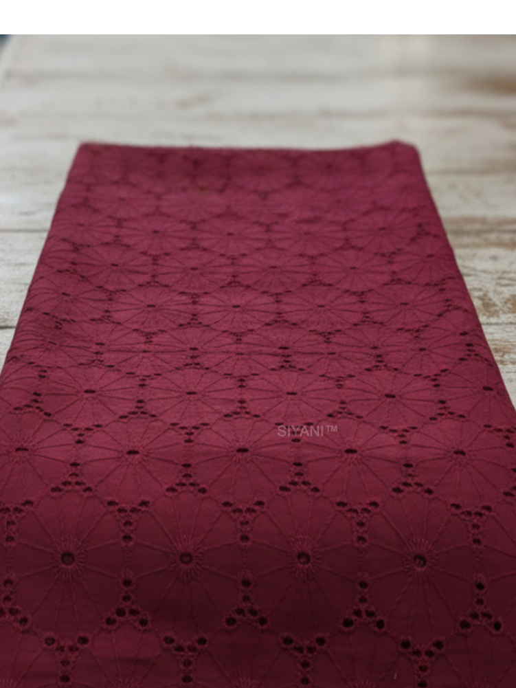 Maroon schiffli eyelet embroidered cotton fabric with geometric floral pattern