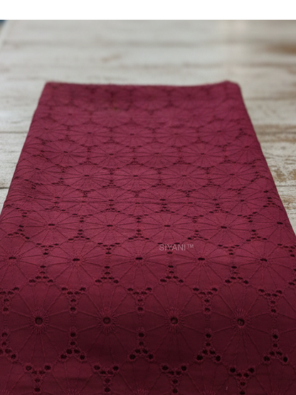 Maroon schiffli eyelet embroidered cotton fabric with geometric floral pattern
