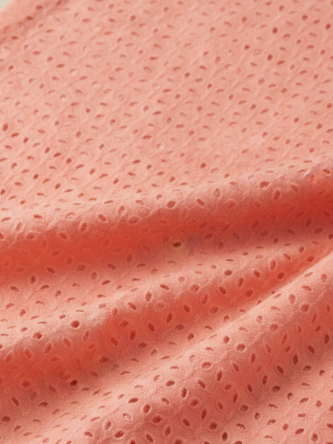 Coral pink six hole schiffli embroidered fabric