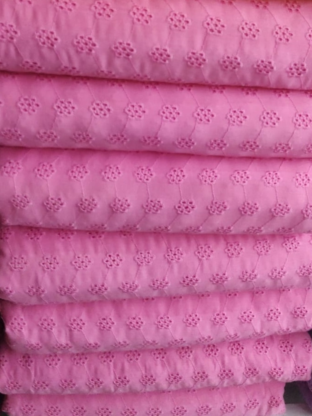 Powder pink floral schiffli embroidered fabric