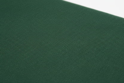 Close-up macro shot of Dark Green Cotton Cambric Fabric showing fine plain weave texture
