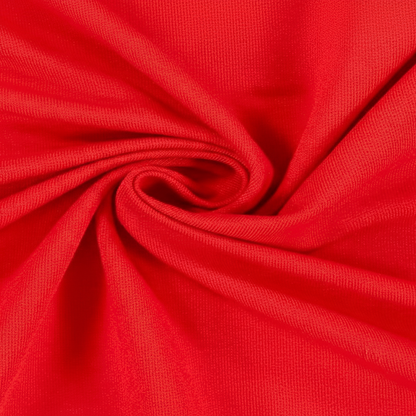 Extreme macro close-up of bright red jam cotton fabric showing ribbed twill weave structure and thread detail