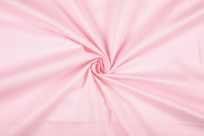 Close-up macro shot of Baby Pink Cotton Poplin Lycra Fabric showing fine rib texture and smooth weave