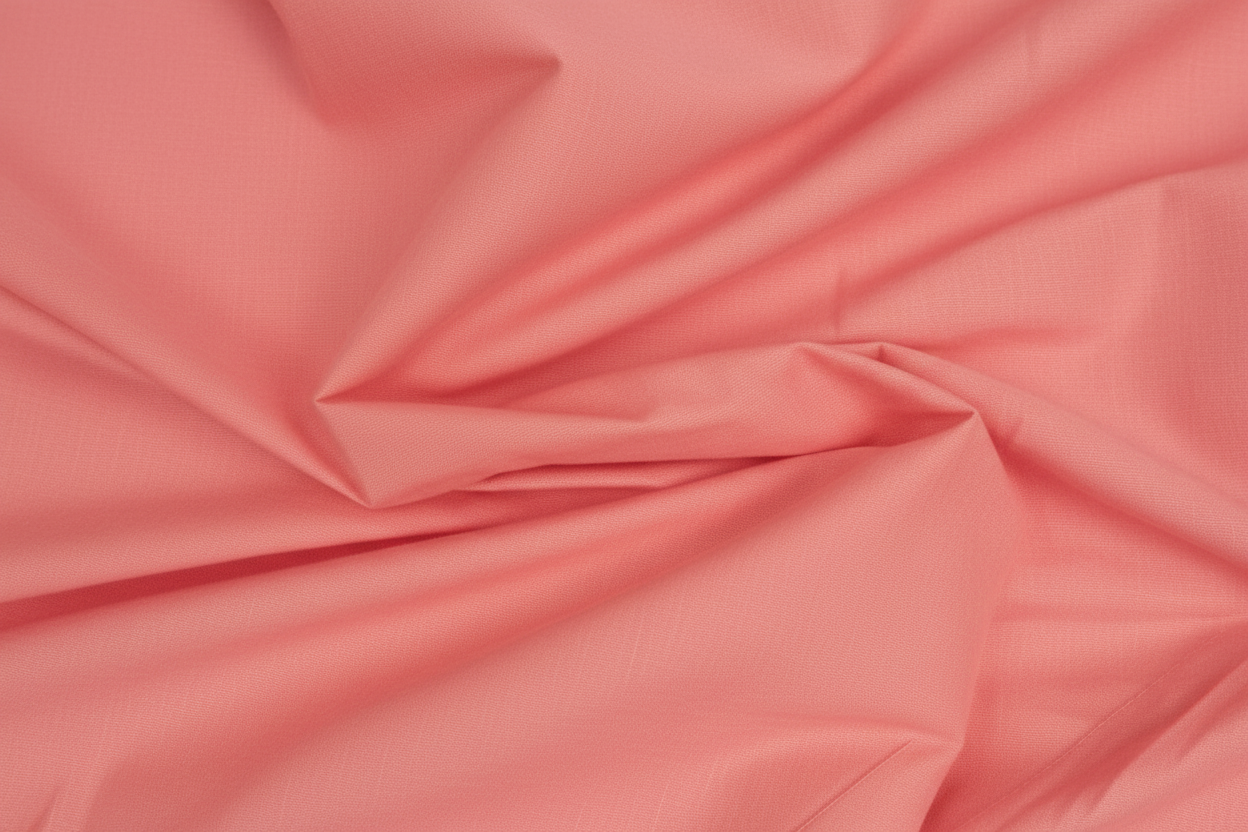 Close-up macro shot of Peach Cotton Cambric Fabric showing fine plain weave texture