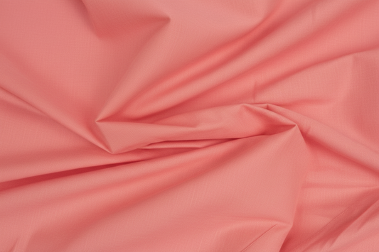 Close-up macro shot of Peach Cotton Cambric Fabric showing fine plain weave texture