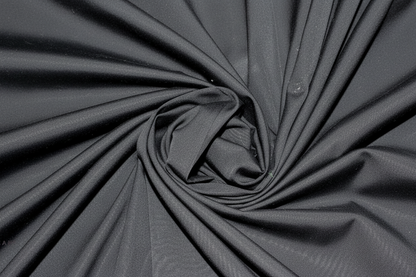 Close-up macro shot of Black Cotton Poplin Lycra Fabric showing fine rib texture and smooth weave