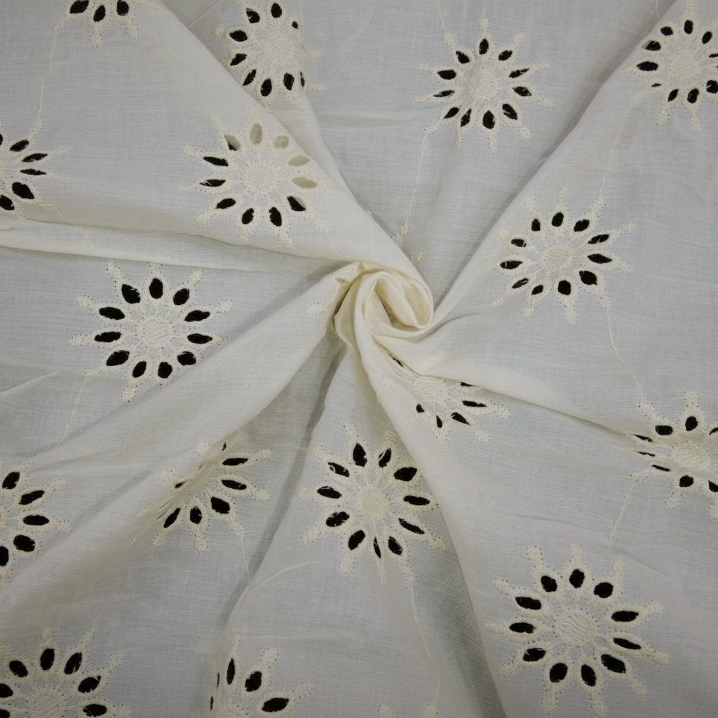 Close-up of natural off-white Kora cotton Hakoba fabric showing floral eyelet cutwork detail
