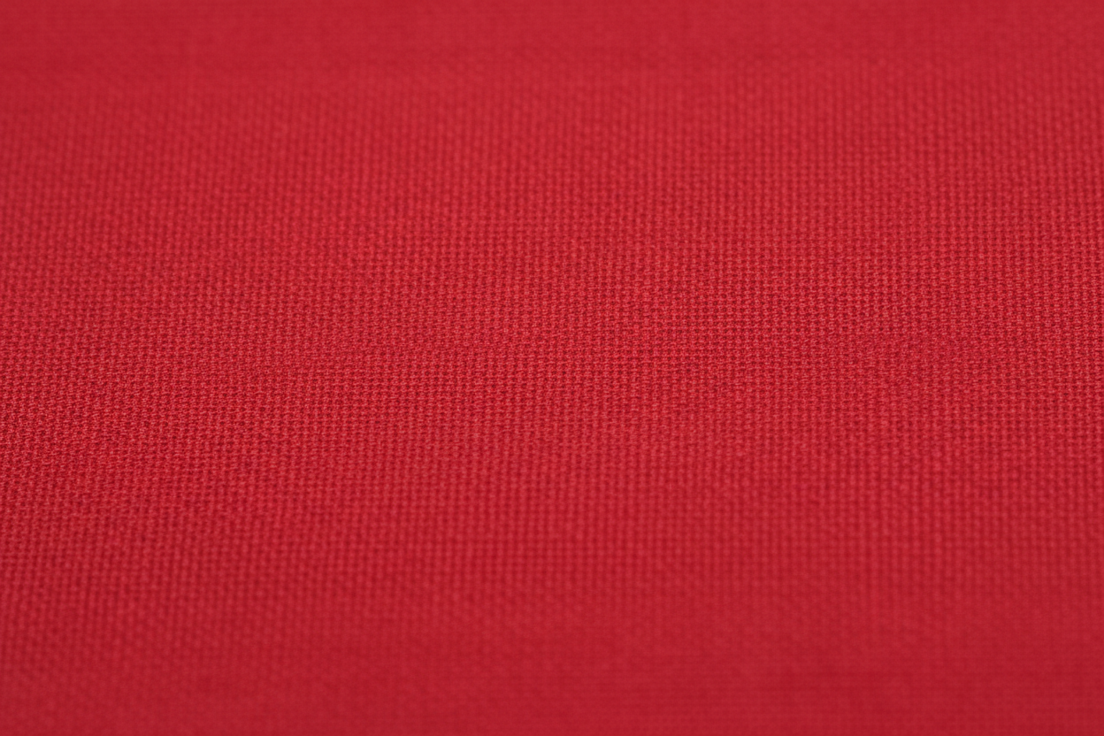 Close-up macro shot of Red Cotton Poplin Fabric showing fine plain weave texture