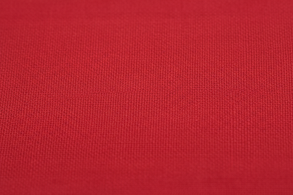 Close-up macro shot of Red Cotton Poplin Fabric showing fine plain weave texture