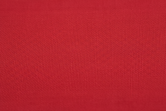 Close-up macro shot of Red Cotton Poplin Fabric showing fine plain weave texture
