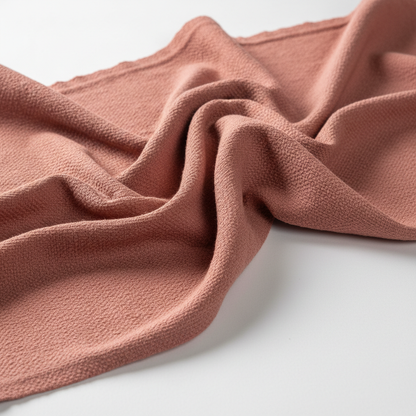Rust pink Jam Cotton fabric draped close-up showing texture and fall