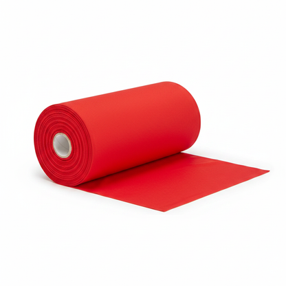 Bright red jam cotton fabric rolled as professional thaan bolt with unrolled section displaying ribbed texture