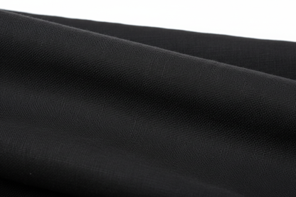Close-up macro shot of Black Cotton Cambric Fabric showing fine plain weave texture