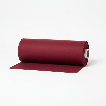 Burgundy jam cotton fabric rolled as professional thaan bolt with unrolled section displaying ribbed texture