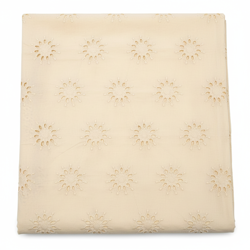 Natural off-white cream Kora cotton Hakoba fabric with floral sunburst eyelet embroidery flat lay