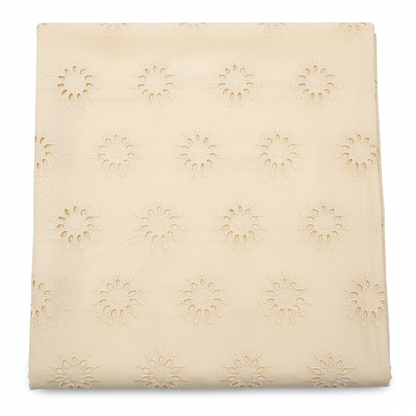 Natural off-white cream Kora cotton Hakoba fabric with floral sunburst eyelet embroidery flat lay