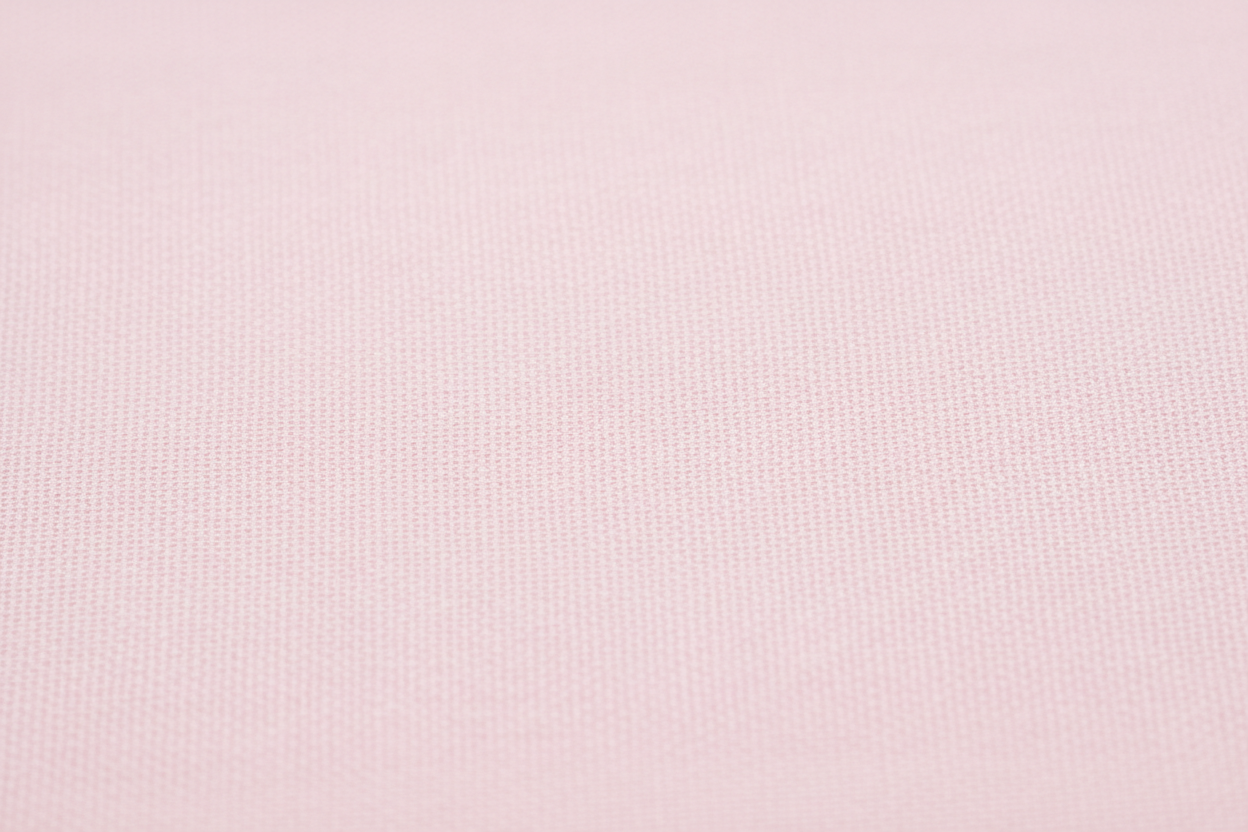 Close-up macro shot of Baby Pink Cotton Cambric Fabric showing fine plain weave texture
