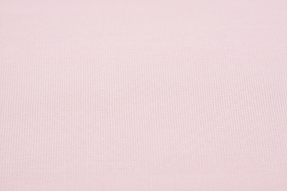 Close-up macro shot of Baby Pink Cotton Cambric Fabric showing fine plain weave texture
