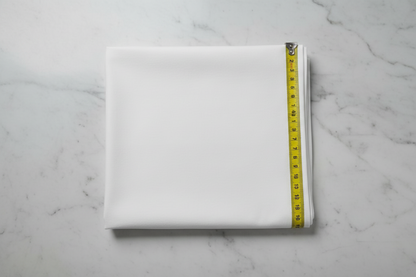 Flat lay of White Cotton Poplin Lycra Fabric with measuring tape showing 44 inch width