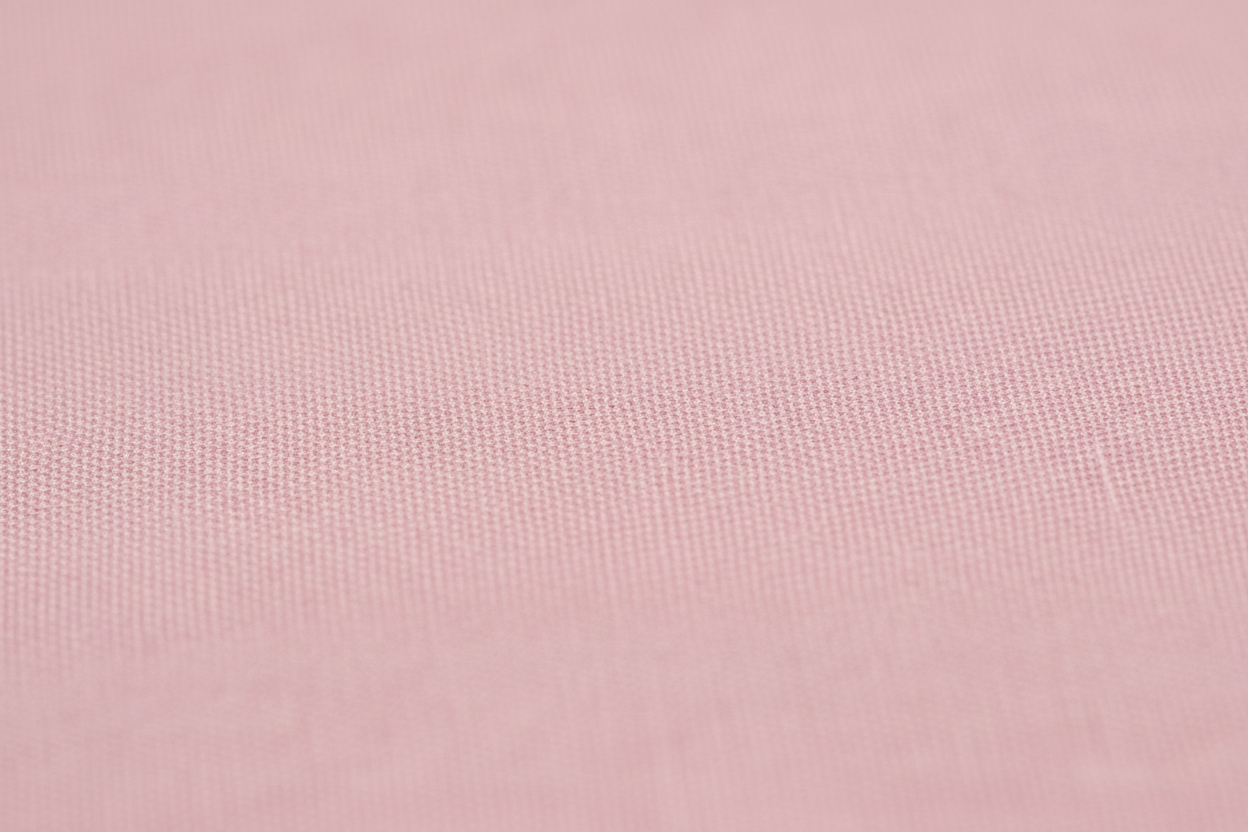 Close-up macro shot of Pink Cotton Cambric Fabric showing fine plain weave texture