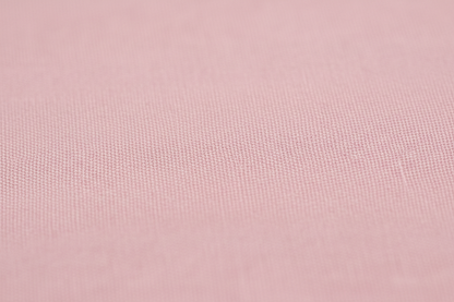 Close-up macro shot of Pink Cotton Cambric Fabric showing fine plain weave texture