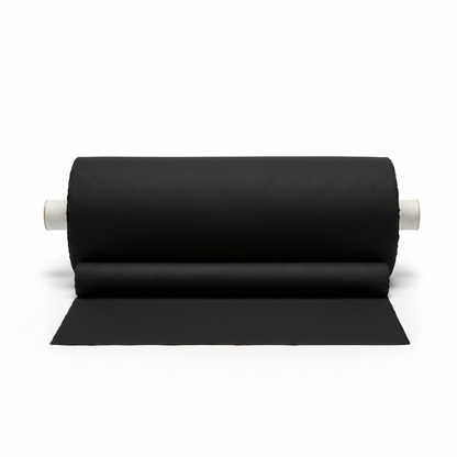 Black jam cotton fabric rolled as professional thaan bolt with unrolled section displaying ribbed texture
