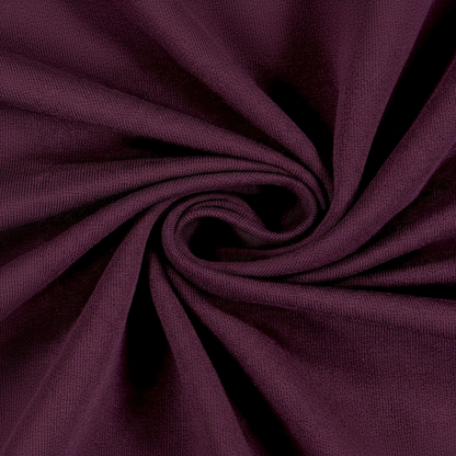 Extreme macro close-up of wine jam cotton fabric showing ribbed twill weave structure and thread detail