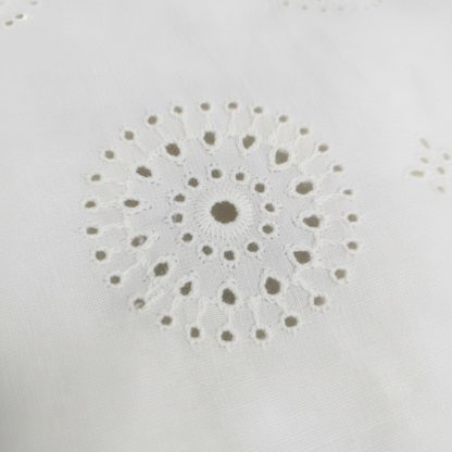 Off-white minimal circular floral medallion Hakoba eyelet embroidery cotton fabric close-up