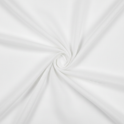 White cotton voile fabric in elegant diagonal fold hero shot, top-down view showing sheer lightweight quality
