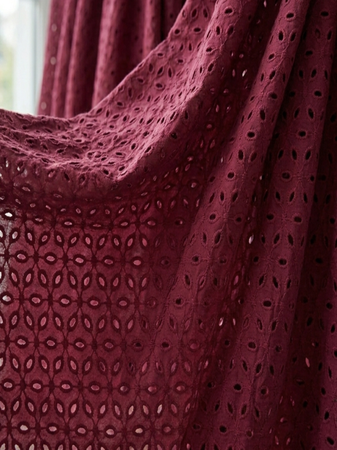 Maroon six hole schiffli embroidered fabric